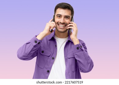 Busy Businessman Talking Using Two Phones, Isolated On Purple Background