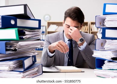 Busy businessman under stress due to excessive work - Shutterstock ID 551850775