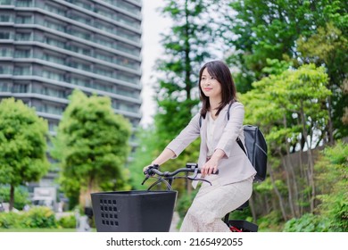 A busy businesswoman commuting to work on a shared bicycle