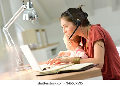 Busy Businesswoman Working With Baby On Lap