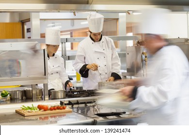 Busy Chefs At Work In The Restaurant Kitchen 