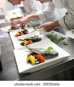 Busy Chefs At Work In The Restaurant Kitchen 