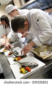 Busy Chefs At Work In The Restaurant Kitchen 