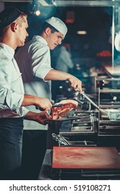 Busy Chefs At Work In The Restaurant Kitchen