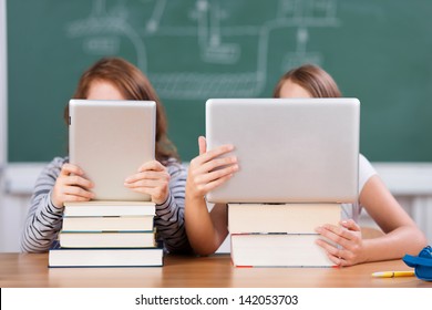 Busy Children Studying With Digital Laptop And Tablet Inside The School