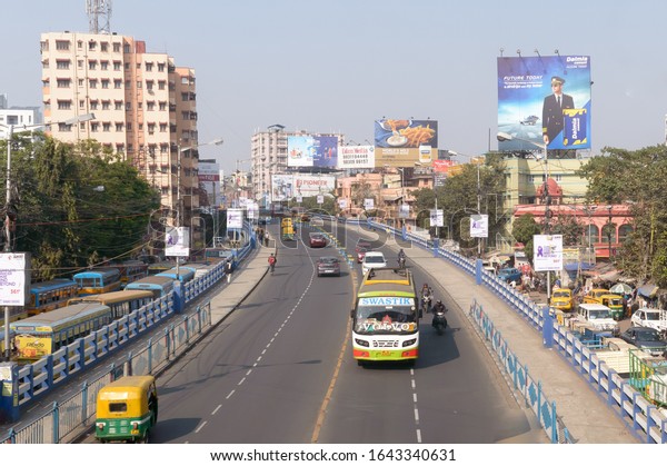 Busy City Street Slow evening rush hour traffic\
movement flow smooth on Dhakuria bridge flyover one of the busiest\
area in Calcutta. Kolkata, West Bengal, India South Asia Pacific,\
January 2020