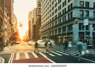 Busy cityscape street scene with people and cars in a crowded intersection on 5th Avenue in Manhattan New York City NYC - Powered by Shutterstock
