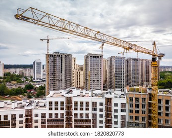 Busy Construction Site And Construction Equipment And Cranes. Aerial Photo.