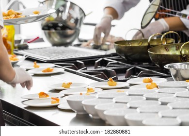 Busy Cooking Of Chefs In Restaurant Kitchen