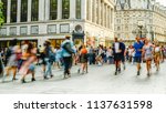 Busy crowds of anonymous motion blurred shoppers on London street