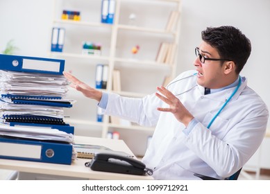 Busy Doctor With Too Much Work In Hospital