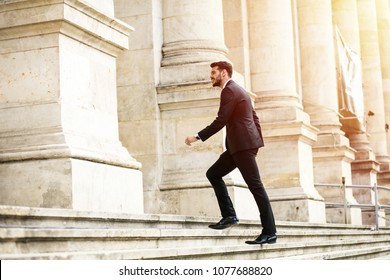 Busy Elegant Stylish Man, Successful Businessman, Walking On Stairs Of Important Building, University Or Law Court Going To An Important Meeting