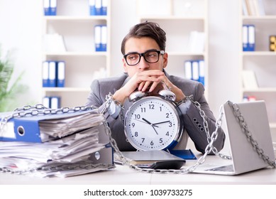 Busy Employee Chained To His Office Desk