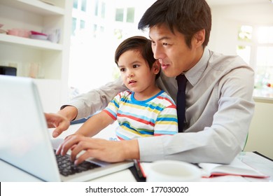 Busy Father Working From Home With Son