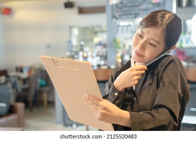 Busy Female Clerk To Contact With Smartphone