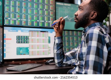 Busy financial analyst sitting at workstation while reviewing investment fund data and real time statistics. Attentive forex stock market trader being mindful while analyzing buy and sell values.