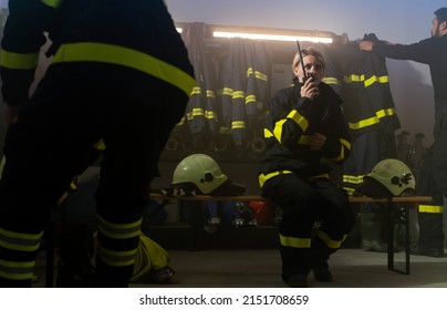 Busy Firefighters Men And Woman Getting Ready For Action Indoors In Fire Station