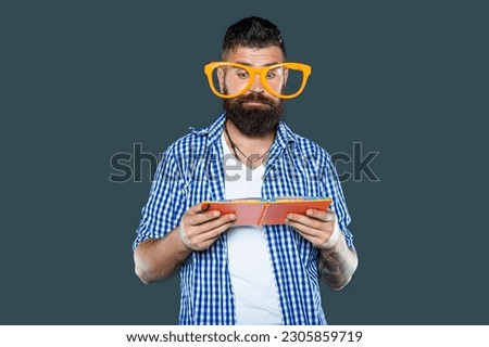 busy funny bearded man in party glasses read book