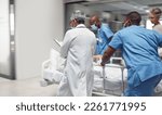 Busy, healthcare and doctors rush with patient, surgery and ready for procedure in hospital. Fast team, medical professional and staff with emergency, accident and health with wellness and nurses