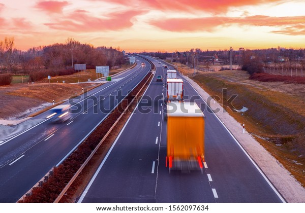 Busy highway with fast moving vehicles in\
beautiful sunset in\
Hungary