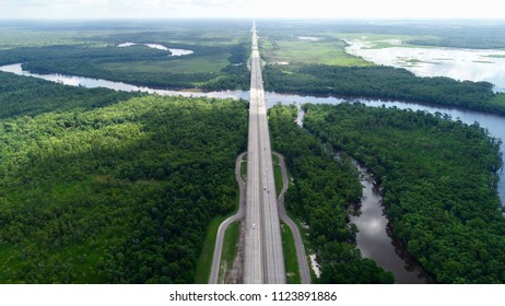 Busy Highway Surrounded By Trees And A The Gorgeous, Curving, Sabine River. This River Is At The Border Between Texas And Louisiana.