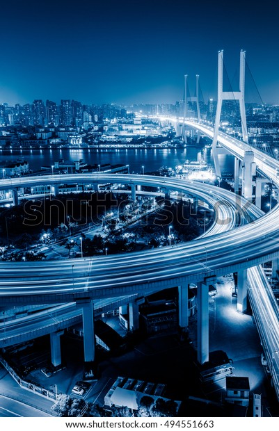Busy highway traffic light trails at night in city\
of China.