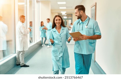 In a busy hospital corridor, two dedicated healthcare professionals have a meaningful conversation, highlighting the importance of teamwork and compassion in their impactful profession - Powered by Shutterstock