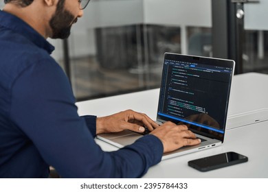 Busy Indian business man software developer engineer working on laptop computer in office. Male administrator programmer specialist coding on pc developing applications. Over shoulder screen view. - Powered by Shutterstock