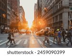 Busy intersection is crowded with people and cars on 5th Avenue and 23rd Street in New York City with sunset background