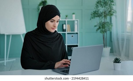Busy Islam businesswoman in black hijab freelancer Islamic Arabian girl student worker Muslim woman female with laptop working e-learning typing online chat e-commerce app web browsing in network - Shutterstock ID 2194428411