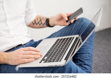 Busy man working with computer and using mobile phone