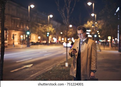 Busy Manager Checking His Phone At Night

