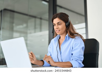 Busy mature business woman call centre representative customer support agent talking to client, smiling middle aged senior female operator wearing headset working using laptop computer in office. - Powered by Shutterstock