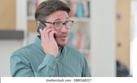 Busy Middle Aged Man Talking On Phone 