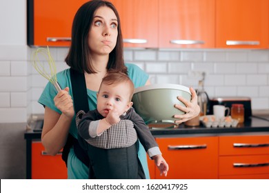 Busy Mom Cooking  Holding Baby In Carrier Baby-wearing System
Mom Making Cookies Carrying Newborn Around The Kitchen
