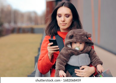 Busy Mother Checking Smartphone At Shopping Spree. Mom With Smartphone Carrying Baby Outside For A Walk
