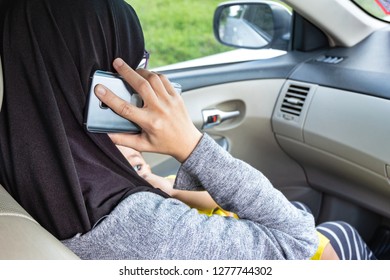 Busy Mother Give Breastfeeding While Talking On Phone In Car.