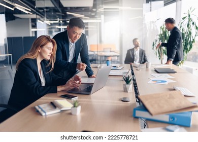 Busy multiethnic coworkers cooperating and working together at office meeting, teamwork concept - Shutterstock ID 2225778721