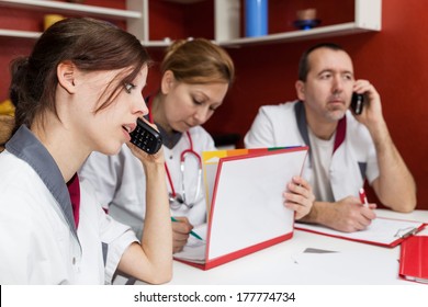 Busy Nurse Staff Is Phoning, Sitting On A Round Table