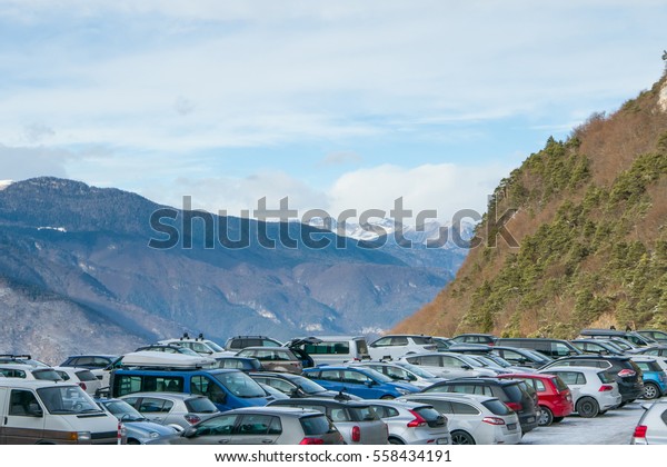 Busy outdoor parking lot in Alpine ski\
resort, parking problems high in the\
mountains.