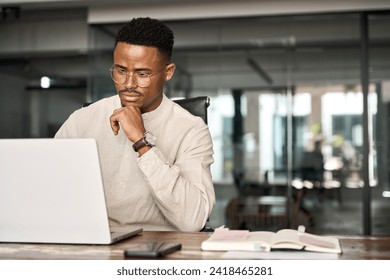 Busy professional African business man company employee, young male businessman looking at computer thinking on online investment or software technology using laptop working at office. Copy space. - Powered by Shutterstock