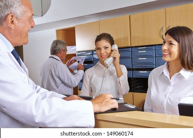 Busy Reception In A Hospital With Doctors And Receptionists