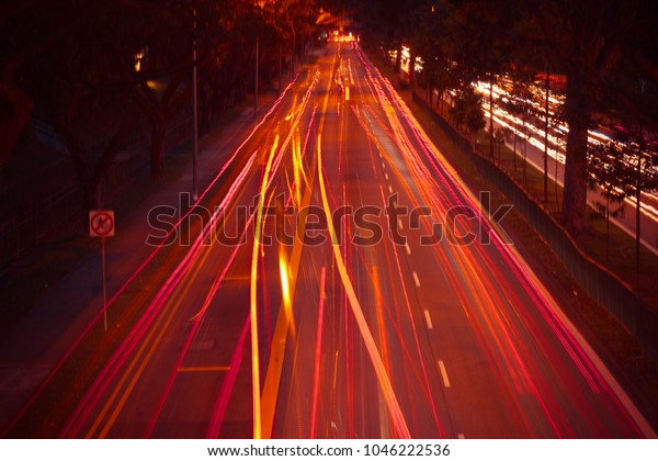 Busy road with cars at night, long exposure of car\
red lights