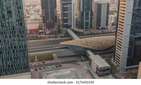 Busy Sheikh Zayed Road Aerial Timelapse, Metro Station With Railway And Modern Skyscrapers Around In Luxury Dubai City. Heavy Traffic On A Highway With Many Cars. United Arab Emirates