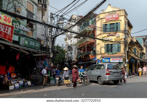 Busy street\
corner in old town Hanoi Vietnam.December 23, 2019 Busy street\
corner in old town Hanoi Vietnam. Most vehicles on the roads of\
Vietnam are motorcycles and\
scooters.