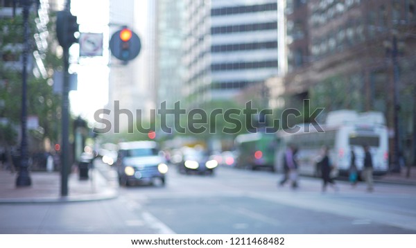 Busy street in San Francisco with traffic and\
office skyscrapers