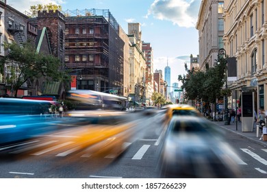 Busy Street Scene With Cars, Taxis And Buses Driving Up 6th Avenue Through Manhattan In New York City NYC