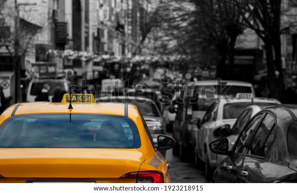 A busy street, a\
taxi stuck in traffic