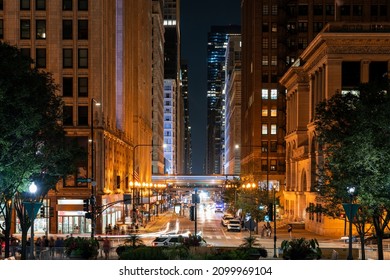 Busy Streets Of Chicago Cityscape At Night Time. Chicago, Illinois, USA. Skyscrapers Of Financial District, A Vibrant Business Neighborhood. Illuminated Cityscape