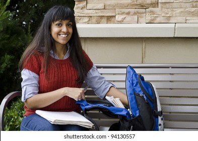 Busy Student Reaching Into Her Bookbag For Something